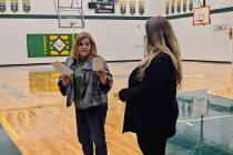 Beatty VFW General Manager Carlotta Marinaro (left) presents the donation to Beatty High teache ...