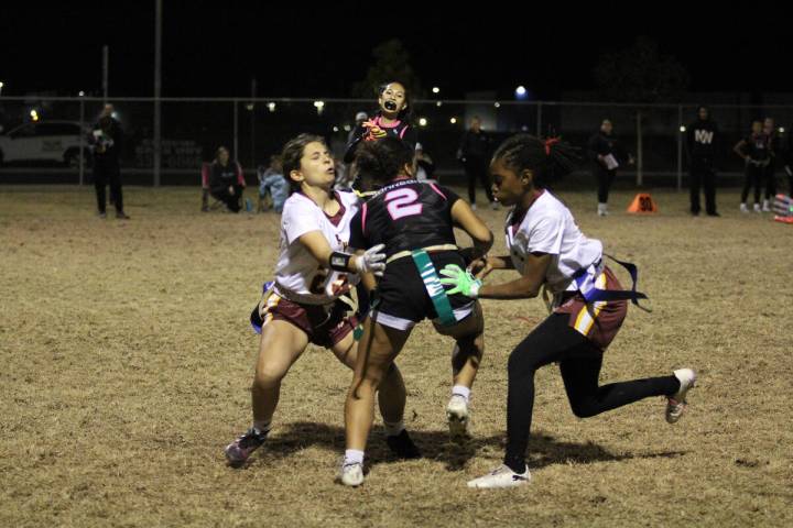 Pahrump Valley High School Trojans attempt to bring down a SLAM! receiver during the girls 49-0 ...