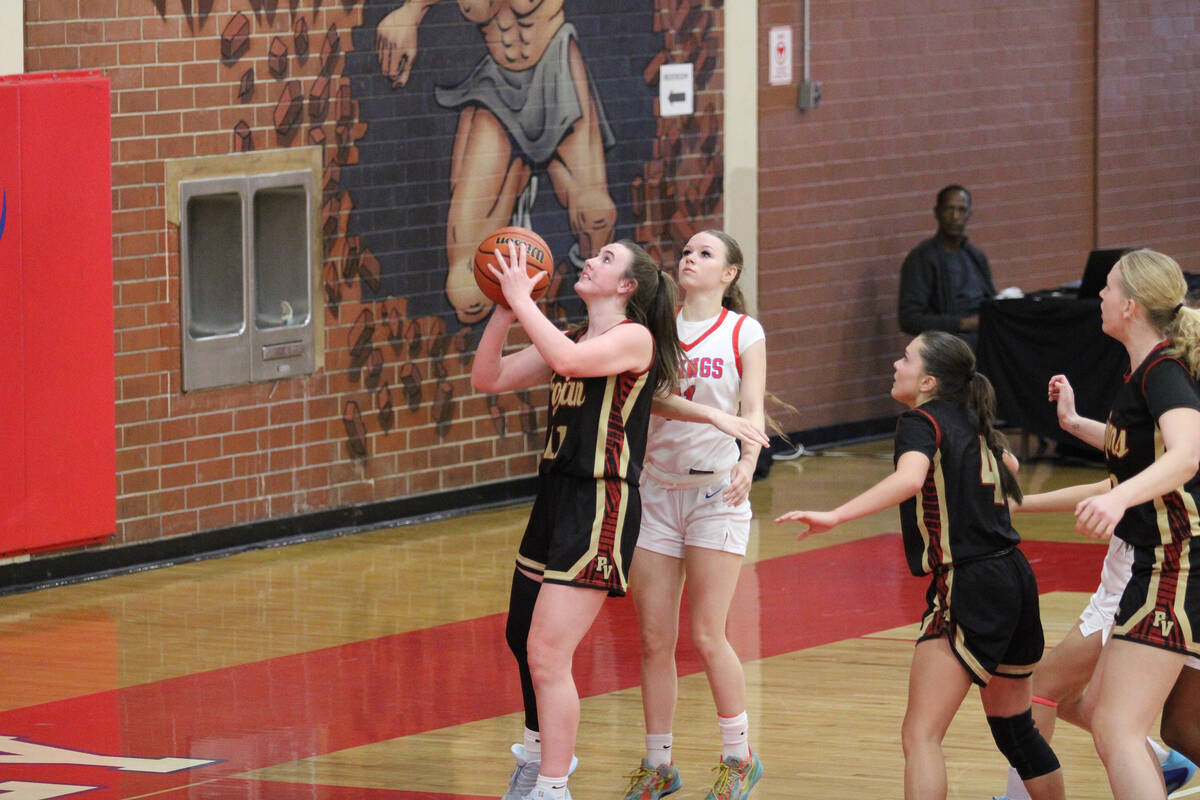 Pahrump Valley High School sophomore Kaitlyn Brown gets inside for the bucket during the Trojan ...
