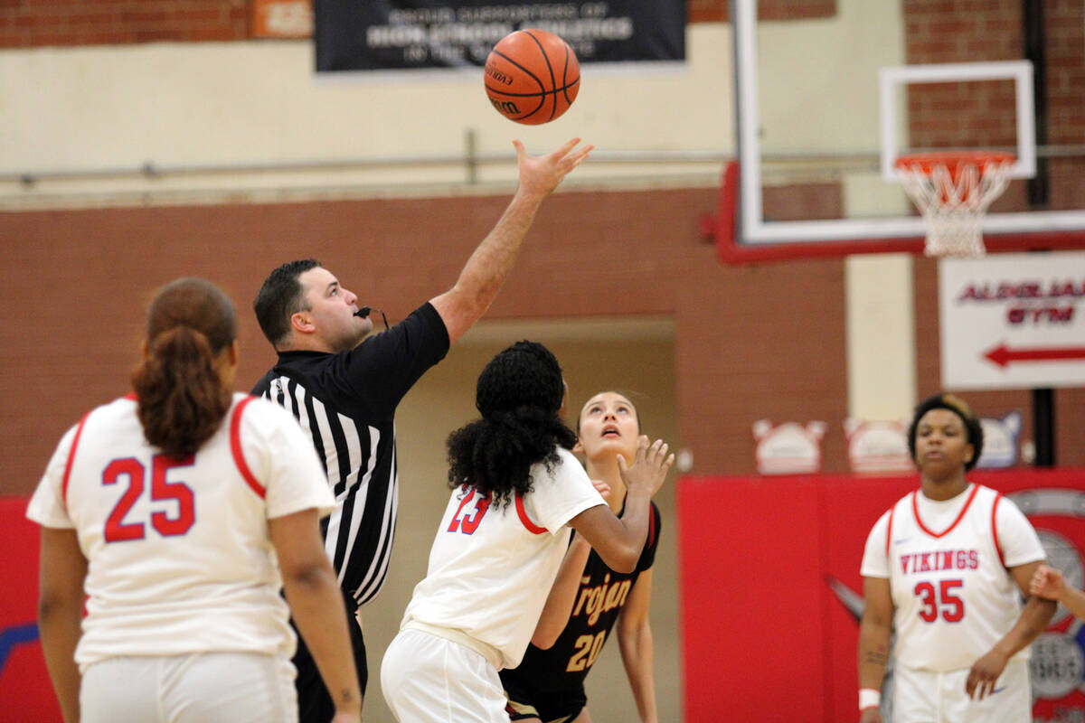 Pahrump Valley High School junior Riley Saldana eyes down the jump ball against Valley High Sch ...