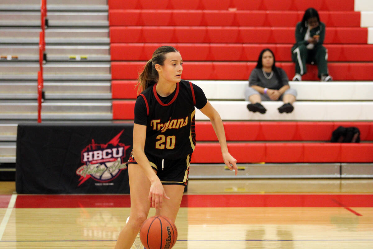 Pahrump Valley High School junior Riley Saldana smoothly transitions the ball up court against ...