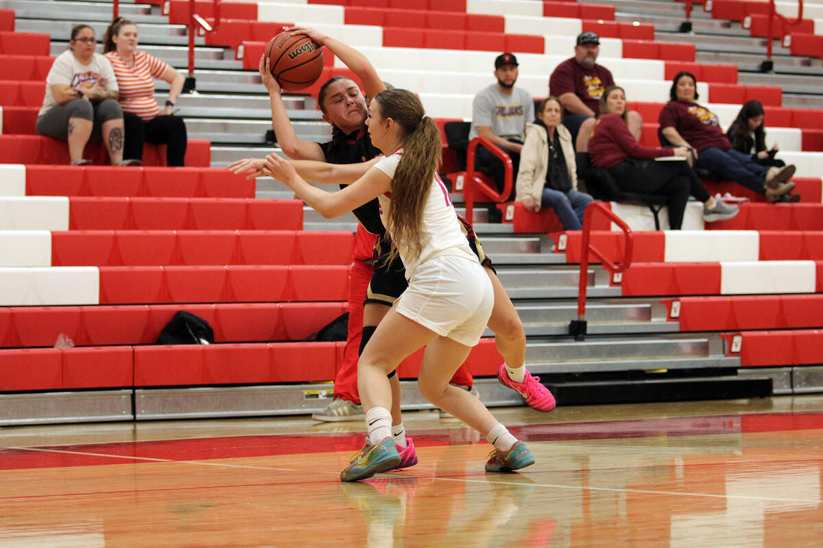Pahrump Valley High School sophomore Aurora Bowers tries to find a way to kick the ball out whi ...