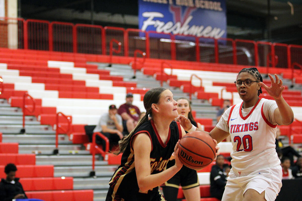 Pahrump Valley sophomore Ella Odegard gets past Valley High School junior MaraMarie Ruckers for ...
