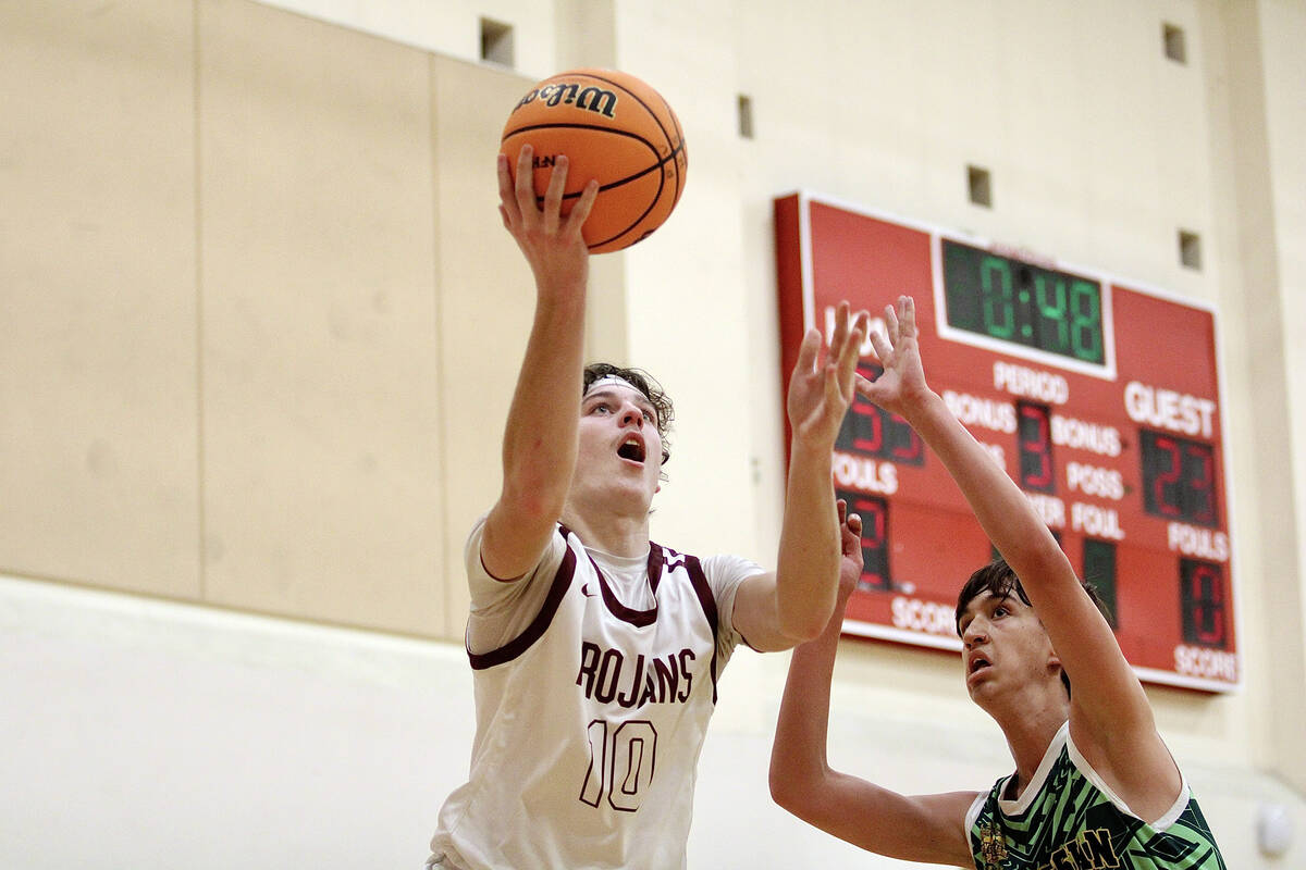 Pahrump Valley High School junior Lucas Gavenda makes his way to the hoop on a layup attempt ag ...