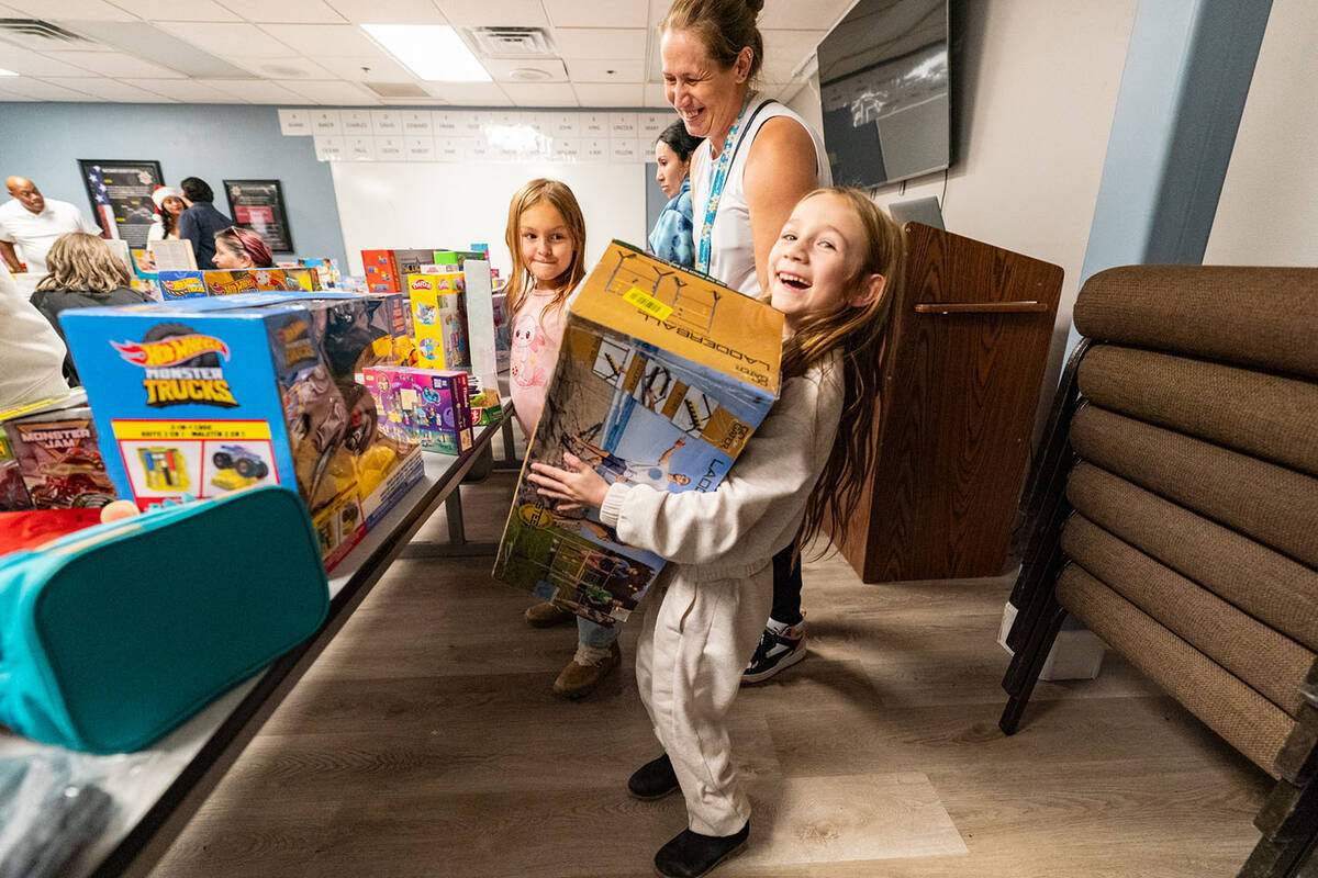 Inside the Sheriff’s Office, tables were filled with all kinds of free toys for attendees to ...