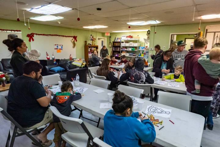 As families waited for their turn to meet and take photos with Santa, they were oﬀered hot co ...
