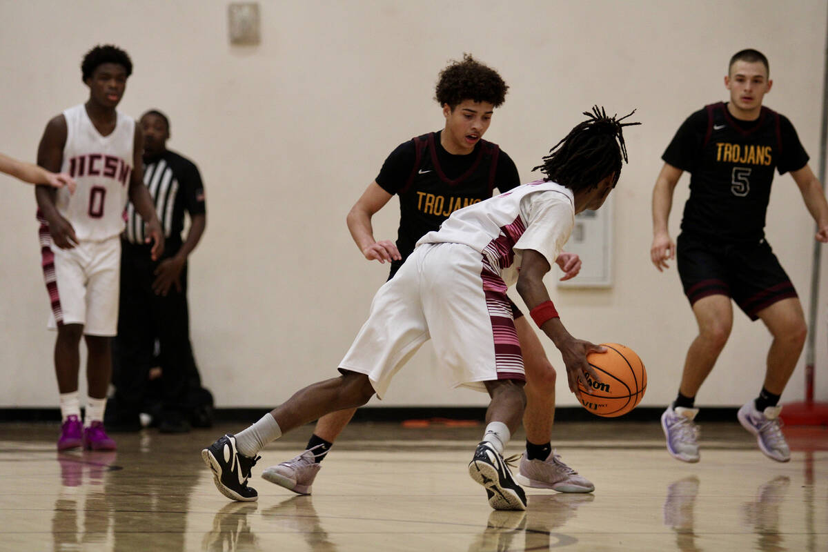 Pahrump Valley High School junior guard Trae Plein does his best to contain an Innovations Inte ...