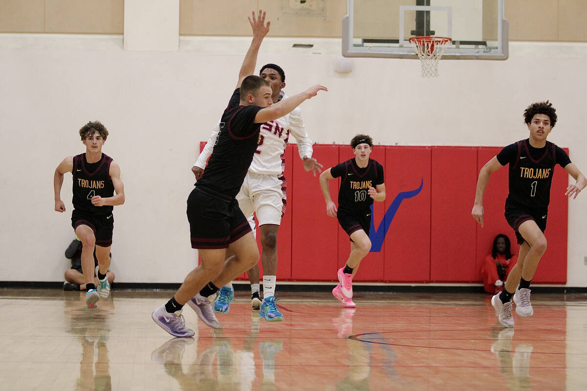 Multiple members of the Pahrump Valley High School boys basketball team attempt to get back on ...