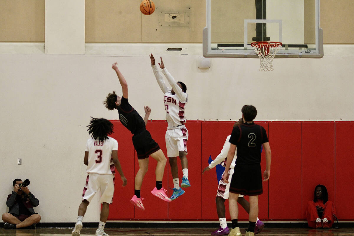 Pahrump Valley High School junior Lucas Gavenda does his best to contort his body away from an ...