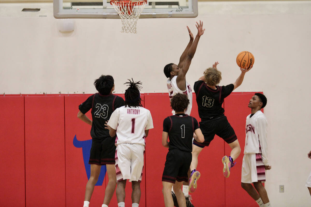 Pahrump Valley High School junior TC Hone goes up for the contested layup during the Trojans 60 ...