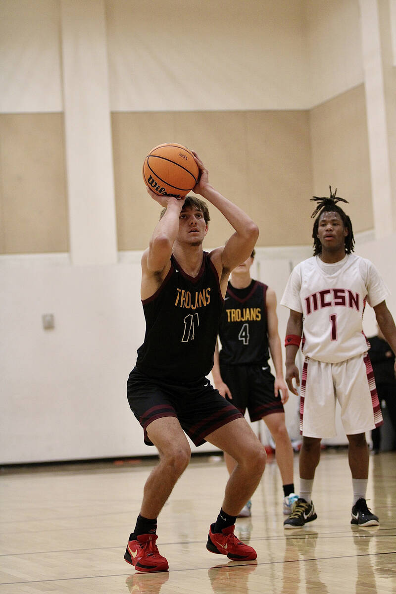 Pahrump Valley High School senior Aydon Veloz attempts a free-throw at the line during the Troj ...