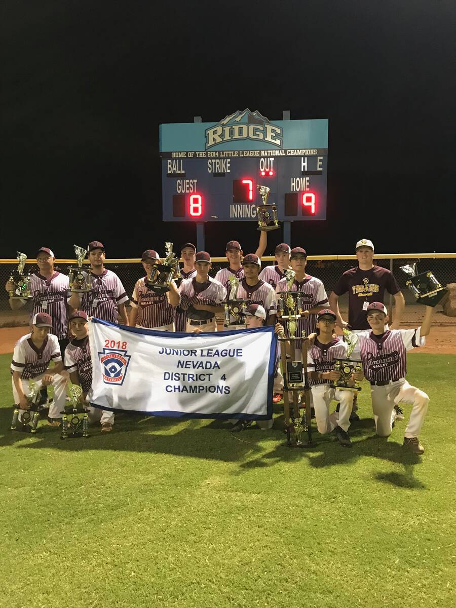 Coach Middleton proudly raises the championship banner with his Pahrump Little League Junior Le ...