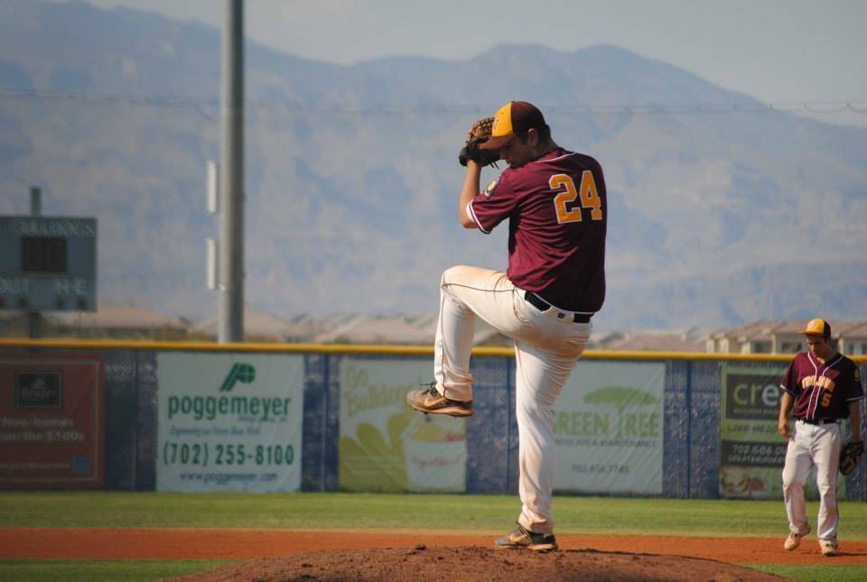 Pahrump Valley High School head coach Drew Middleton pitches during a home game for the Trojans ...