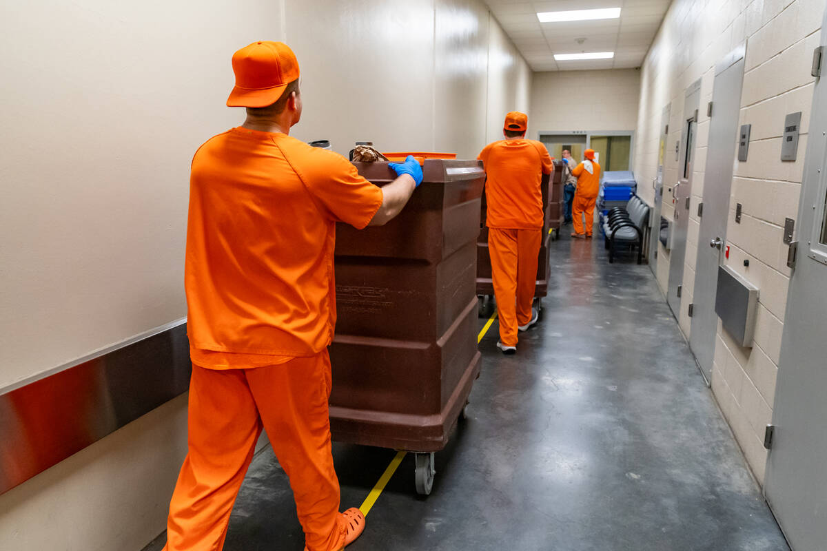 Inmate trustees wheel the Christmas Eve dinners into the inmate housing units. (John Clausen/Pa ...