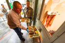 Sheriﬀ McGill sides a dinner in a food port in the door of an inmate’s cell. (John Clausen/ ...