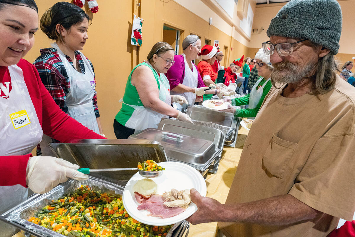 The buffet line at the Community Christmas Eve Dinner saw plenty of action as hundreds of atten ...
