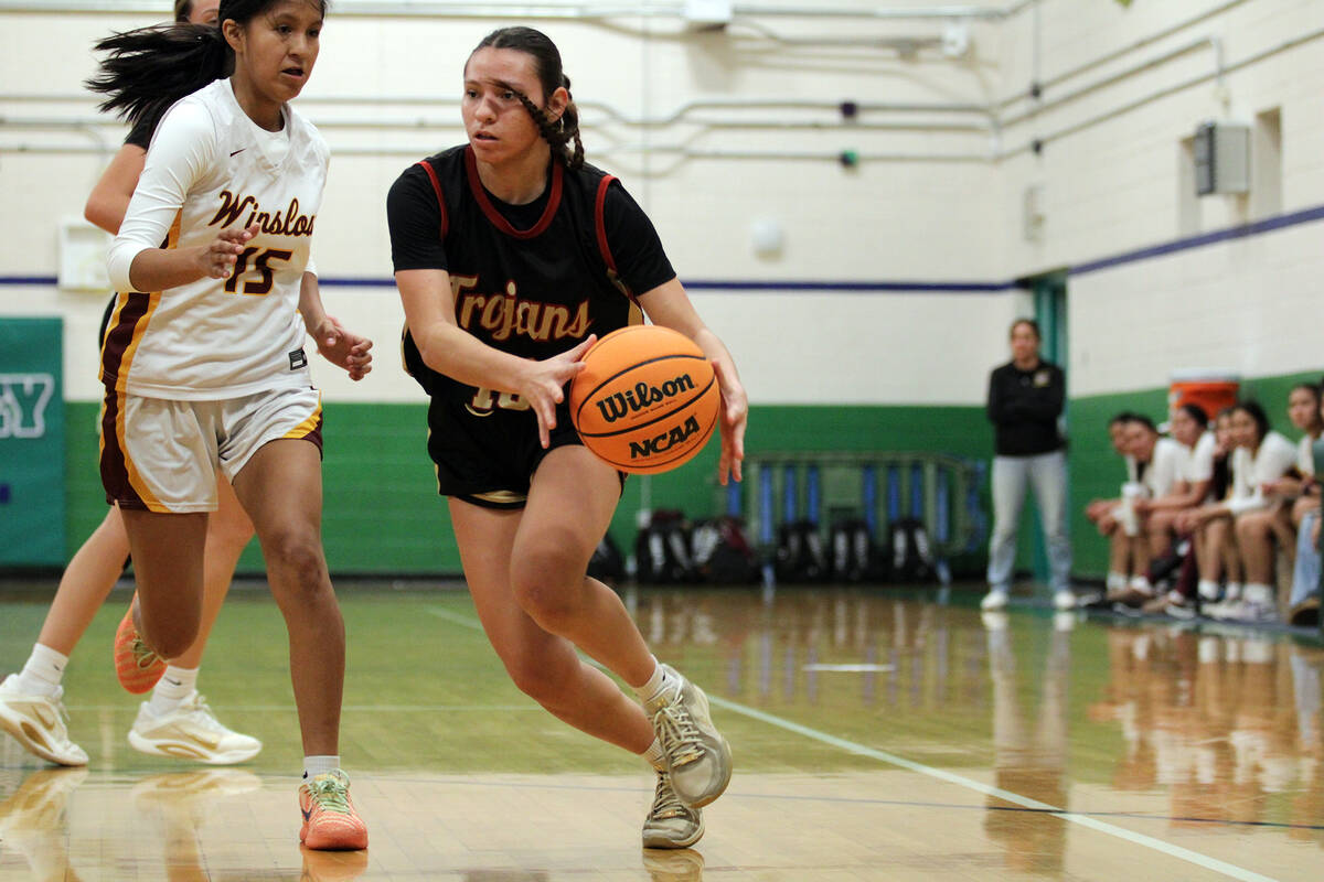 Pahrump Valley High School junior Autumn Colon fights her way to secure a layup against Winslow ...