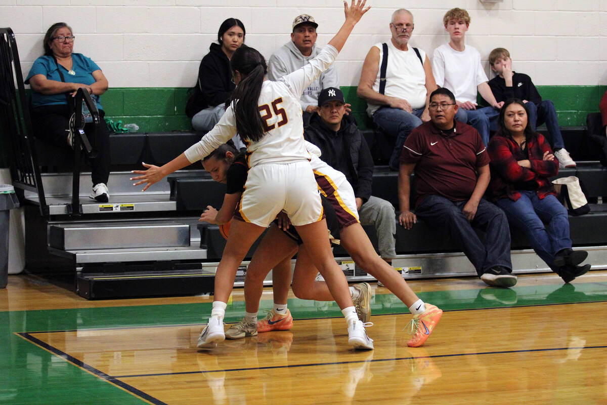 Pahrump Valley High School junior Autumn Colon is double-teamed in the corner during the Trojan ...