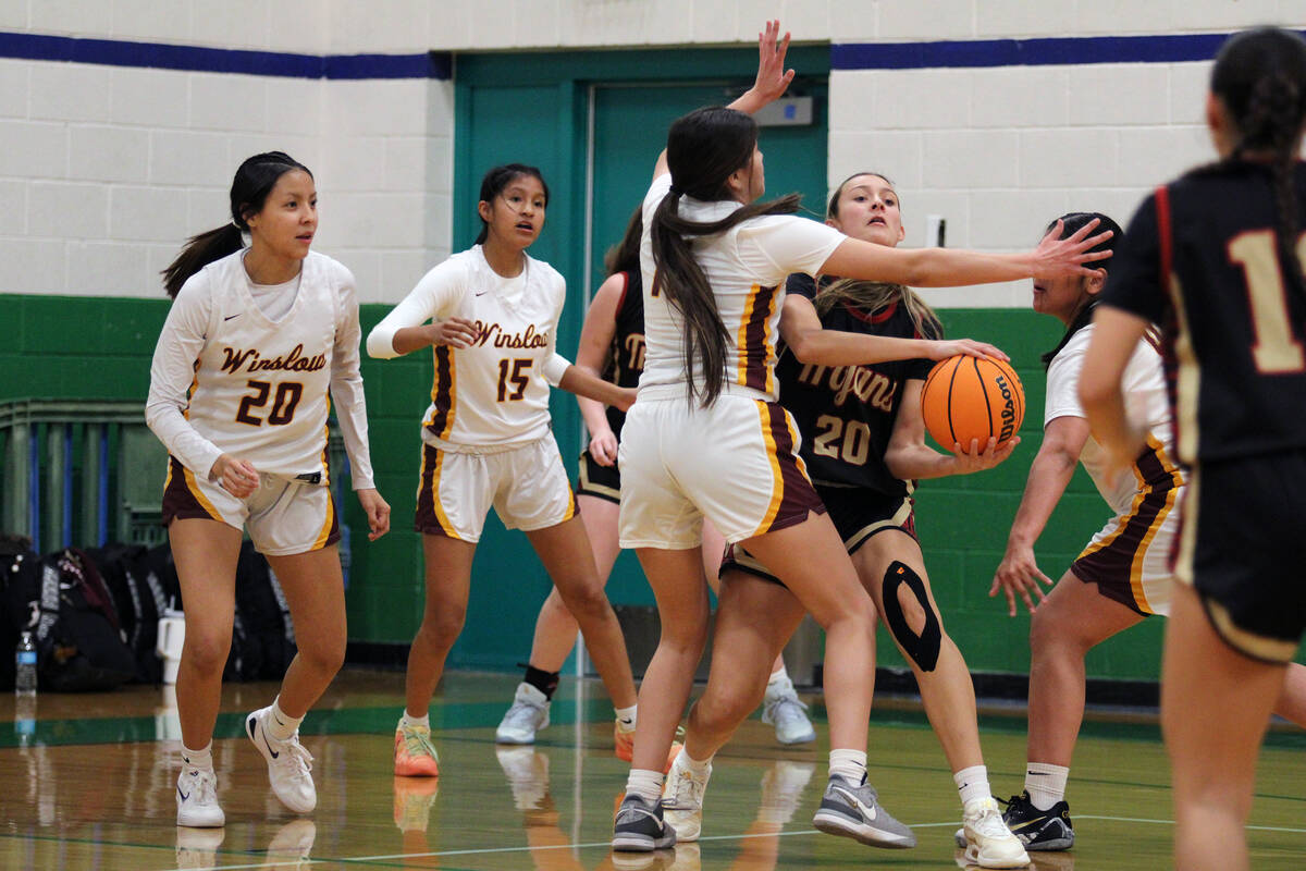 Pahrump Valley High School junior Riley Saldana runs into heavy traffic against multiple Winslo ...