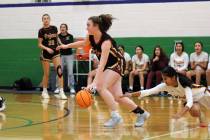 Pahrump Valley High School sophomore Kaitlyn Brown advances the ball past a Winslow defender du ...
