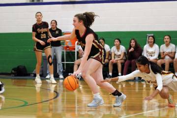Pahrump Valley High School sophomore Kaitlyn Brown advances the ball past a Winslow defender du ...