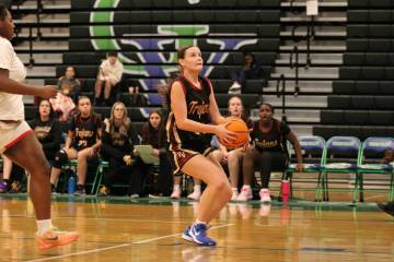 Pahrump Valley High School sophomore guard Ella Odegard drives in for the layup attempt during ...