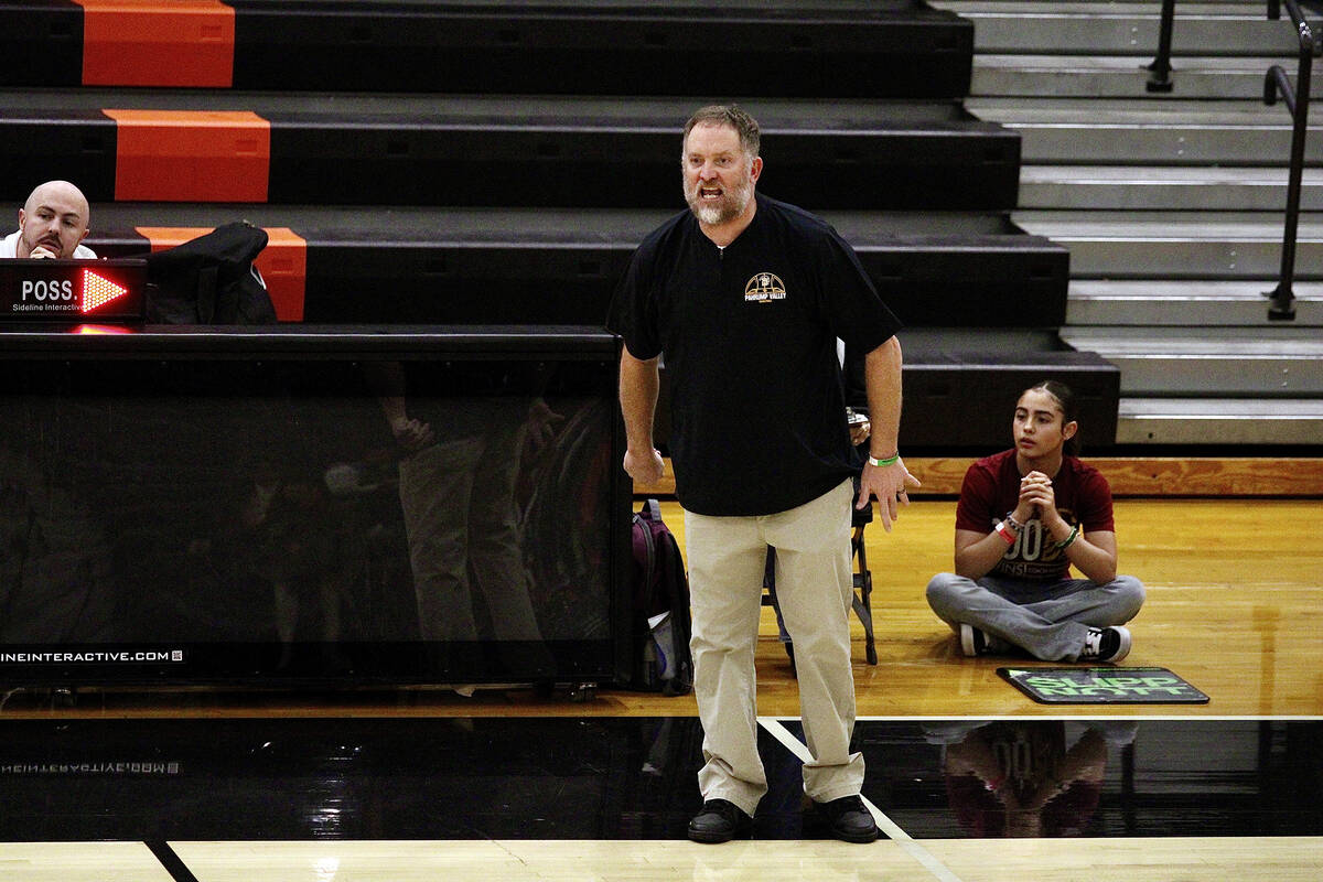 Pahrump Valley High School basketball head coach Toby Henry gets passionately fired up while co ...