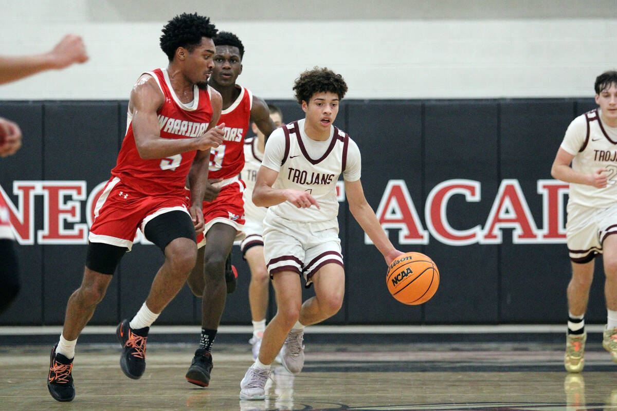 Pahrump Valley High School junior guard Trae Plein drives advances the ball up court against We ...