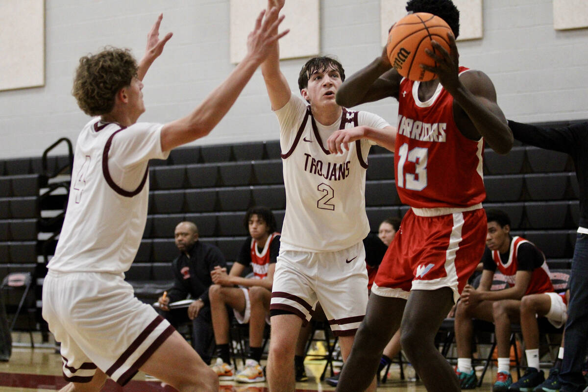 Pahrump Valley High School's Keir Sheppard and Caden Briscoe double team a Western High School ...
