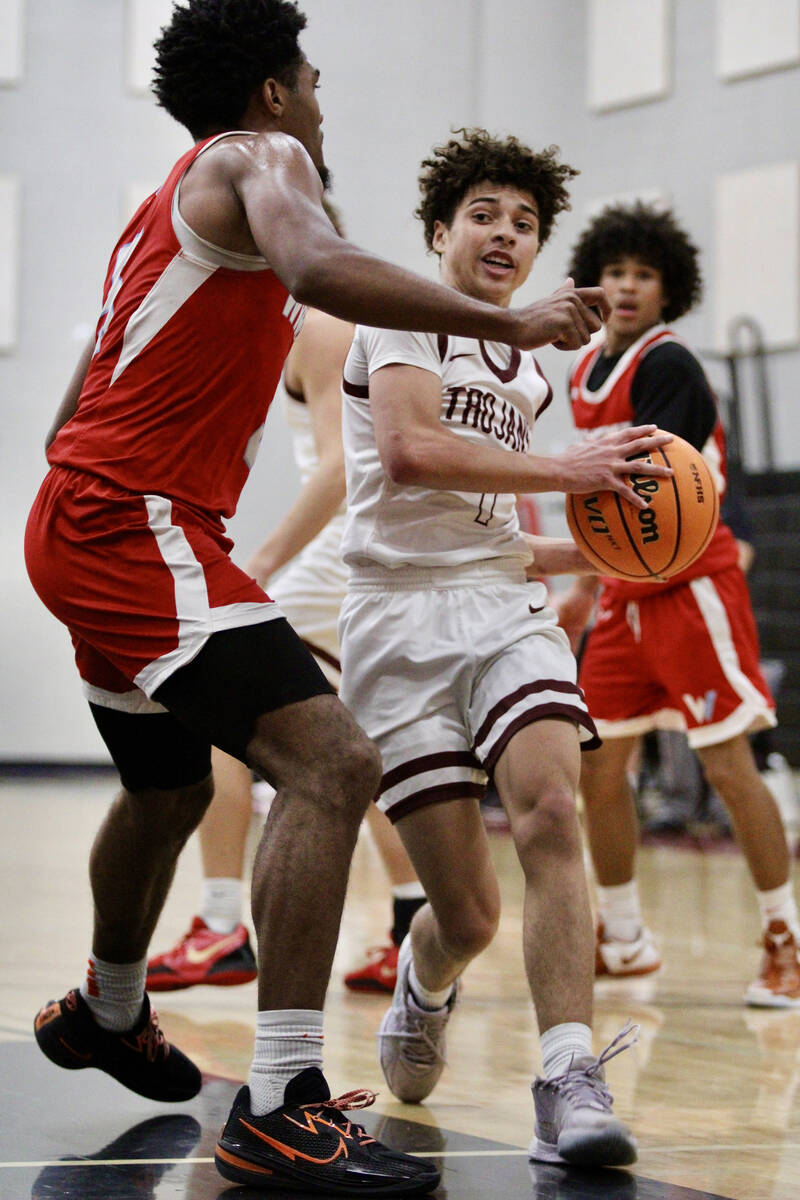 Pahrump Valley High School junior guard Trae Plein drives inside against Western senior AC McDo ...