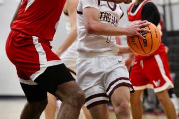 Pahrump Valley High School junior guard Trae Plein drives inside against Western senior AC McDo ...