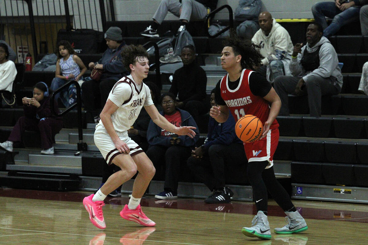 Pahrump Valley High Schools junior Lucas Gavenda plays man defense on Western junior Shem Green ...