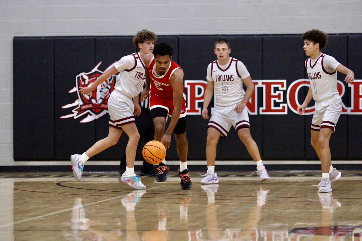 Western High School senior AC McDowell secures a rebound and advances the ball to mid-court aga ...