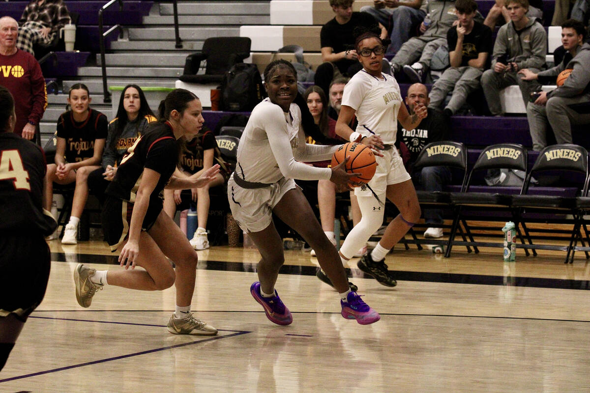 Pahrump Valley High School junior Autumn Colon does her best to contain Sunrise Mountain senior ...