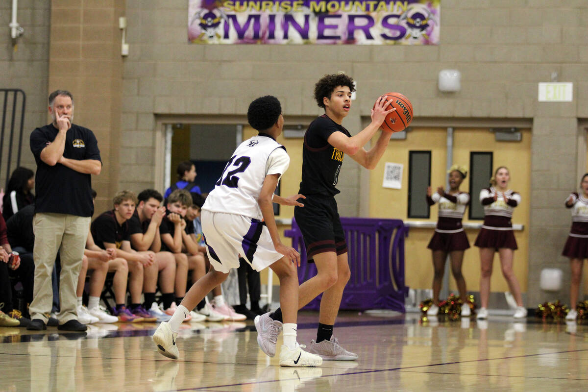 Pahrump Valley High School junior Trae Plein scans the court for an open man as Sunrise Mountai ...