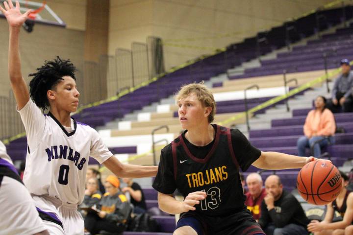 Pahrump Valley High School junior TC Hone looks to find an open man against Sunrise Mountain's ...