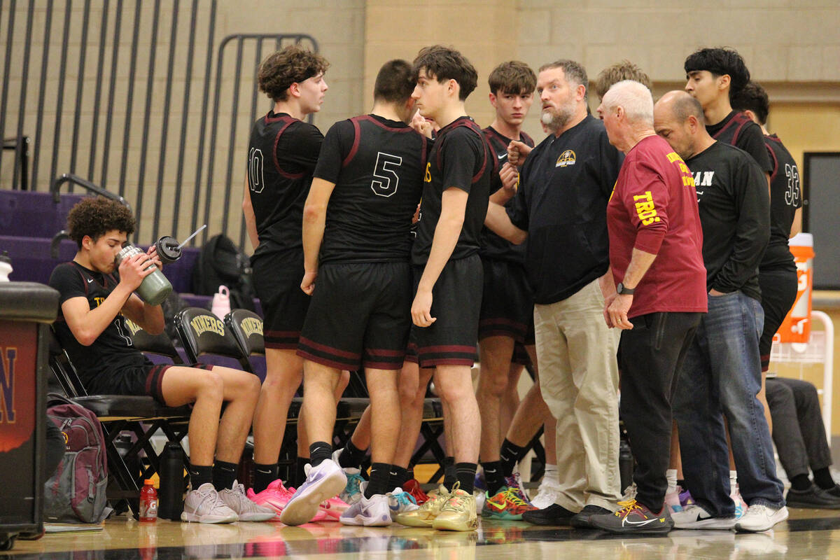 Pahrump Valley High School boys basketball head coach Toby Henry calls for a timeout as the Tro ...