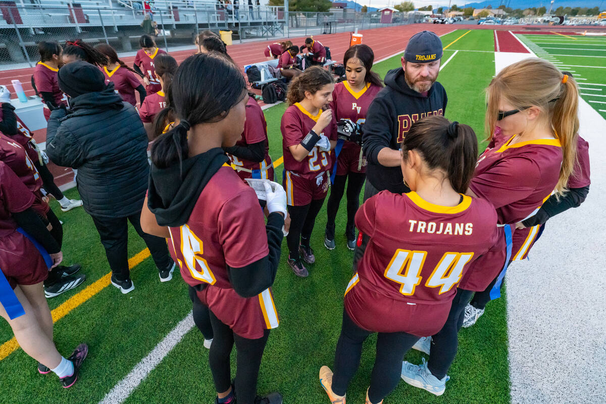 The Pahrump Valley High School flag football team huddles together with head coach Jeff Corbett ...