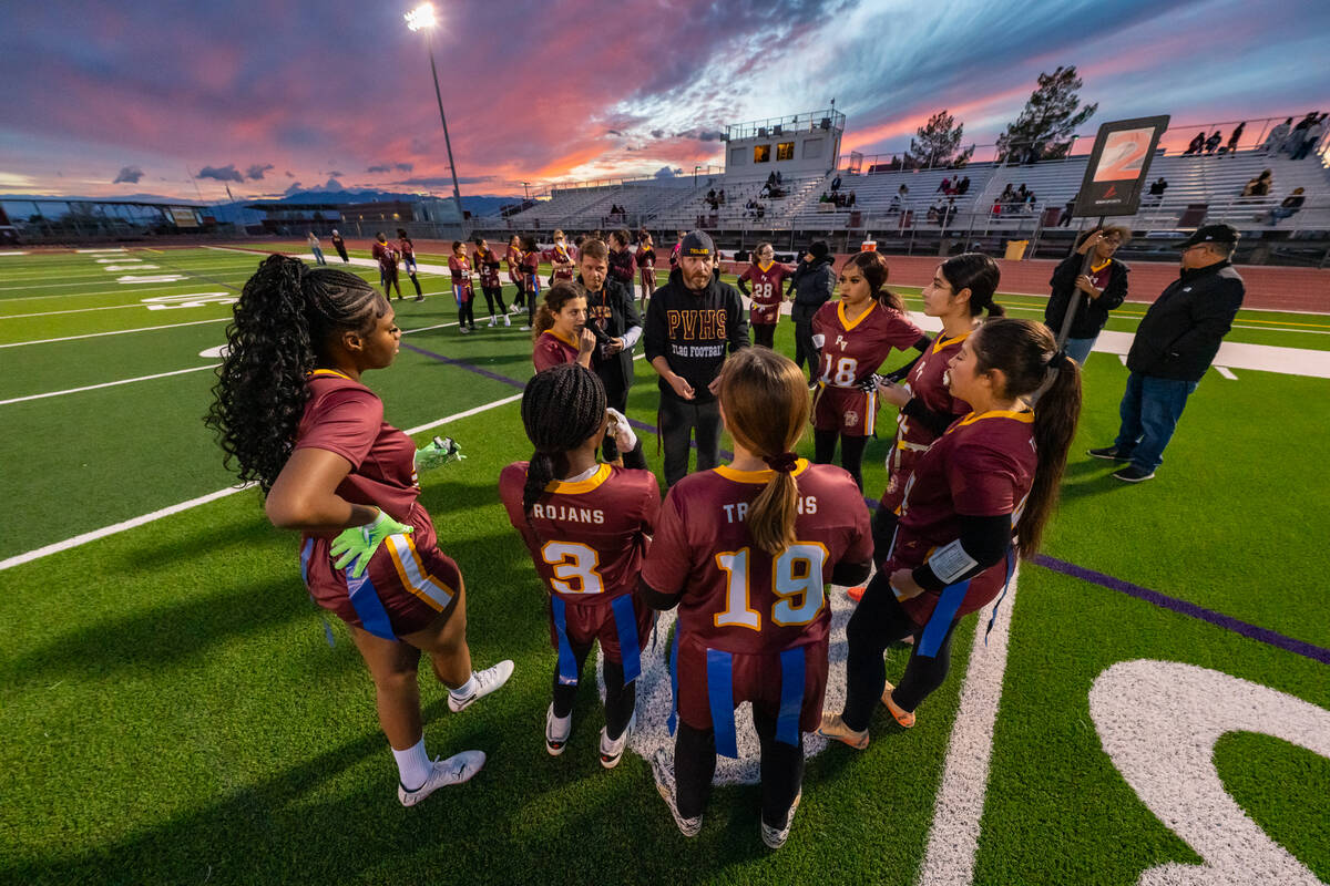 The Trojans huddle together for a timeout during their first home league game of the season fol ...