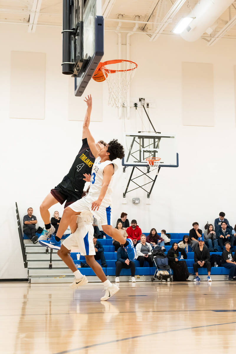 Pahrump Valley High School senior Keir Sheppard drives in for a layup against a Cristo Rey defe ...