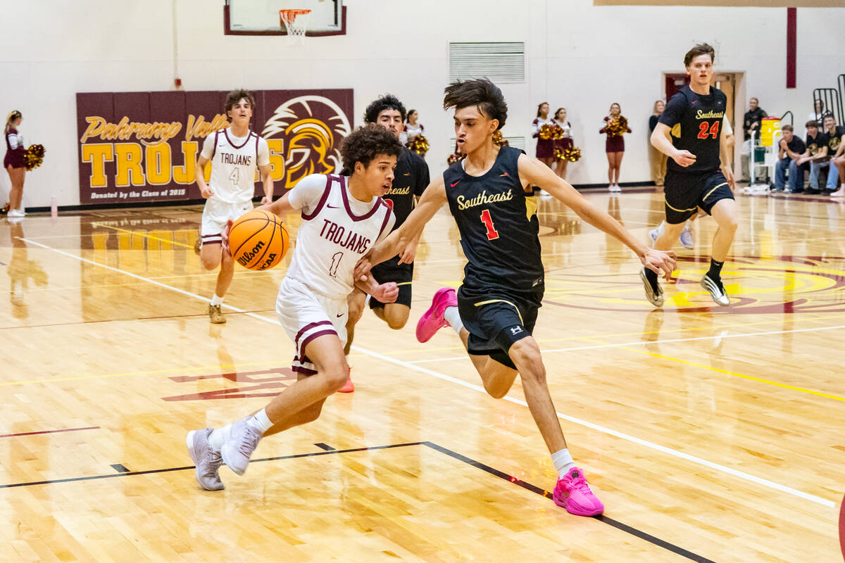 PVHS junior Trae Plein does his best to evade SECTA senior shooting guard Rikkie Rodriguez down ...