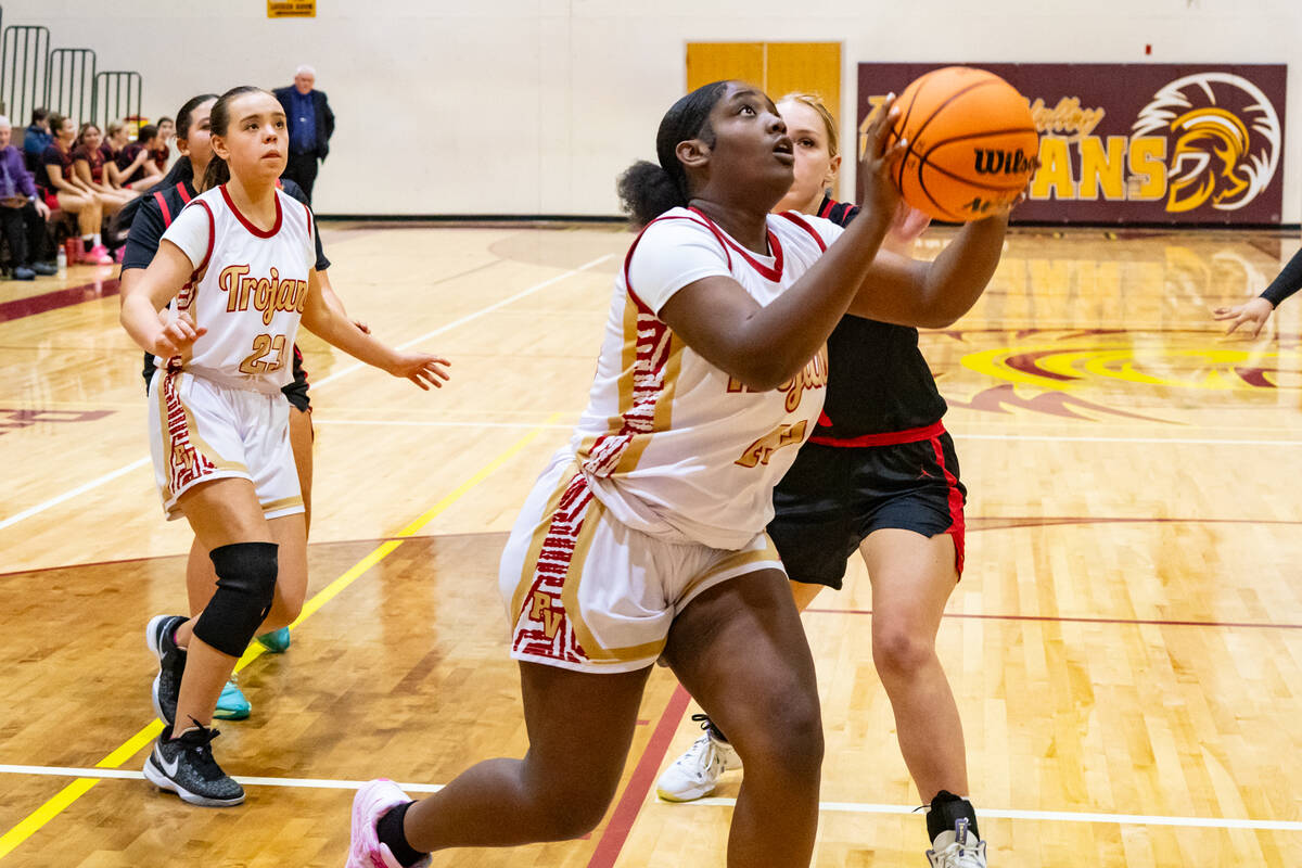 Pahrump Valley High School sophomore Adrian Rogers secures the ball to go for a layup against S ...
