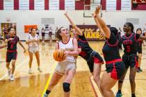 Pahrump Valley High School sophomore Kaitlyn Brown comes in hard into double coverage during a ...