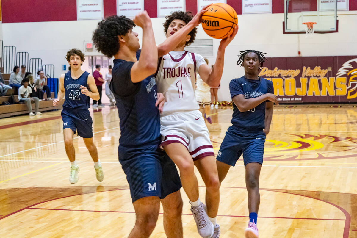 Pahrump Valley High School junior Trae Plein tries to drive in on the Mustangs during the Troja ...
