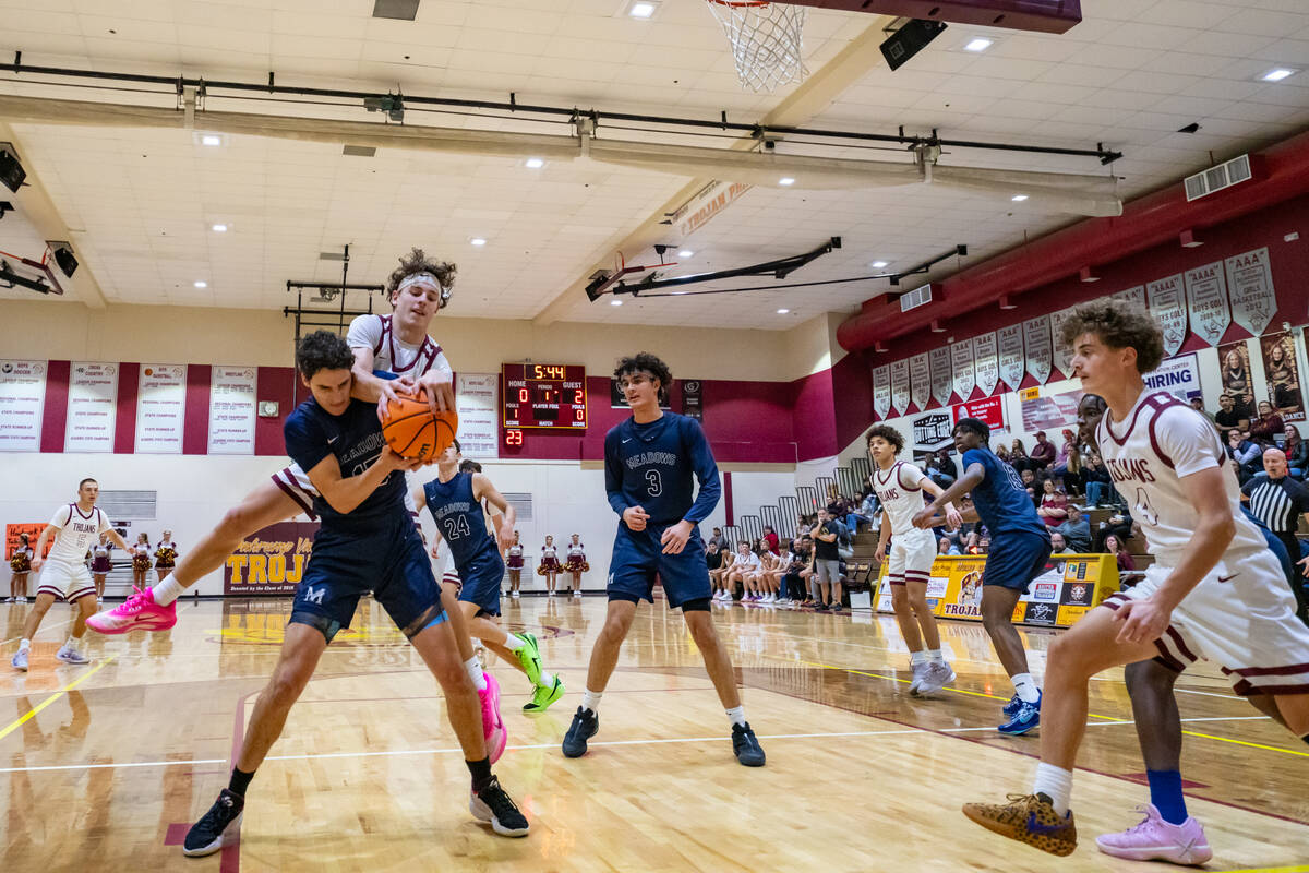 Pahrump Valley High School junior Lucas Gavenda catches some air time while fighting for the ba ...