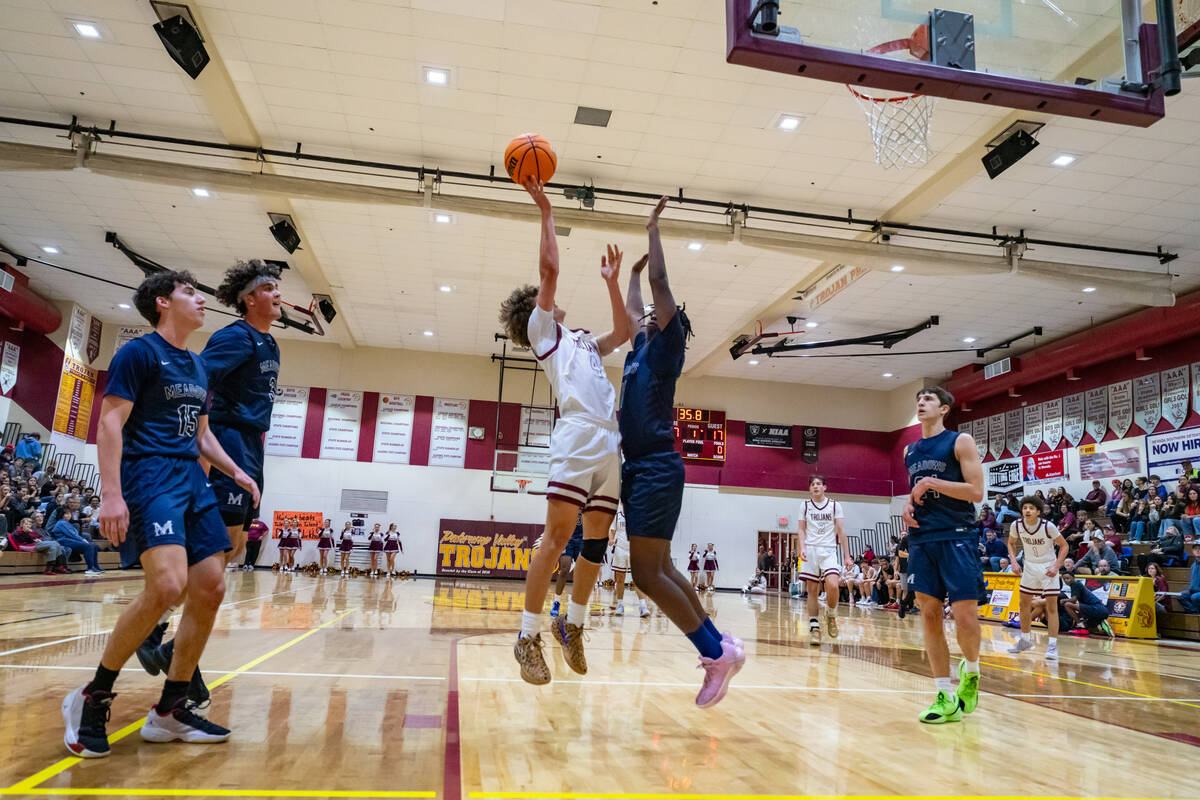 Pahrump Valley High School senior Keir Sheppard does his best to drive past the Meadows junior ...