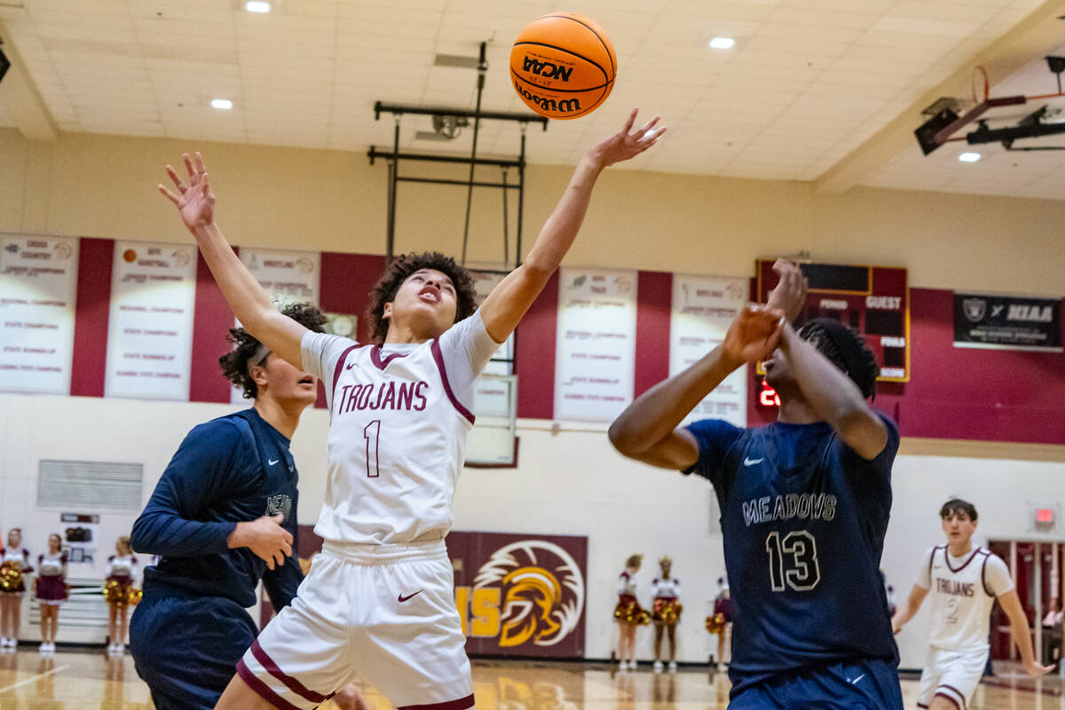 Pahrump Valley High School junior Trae Plein tries to secure possession of the ball against the ...