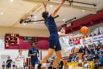Pahrump Valley High School senior Keir Sheppard tries to elevate himself past a Meadows defende ...