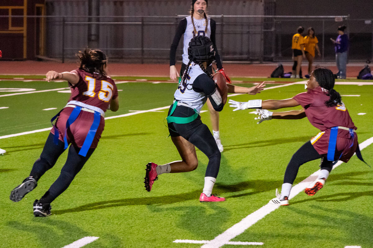 Pahrump Valley High School's Ember Castaneda-Dabney and Ma'liyah Collins try to double-team Dur ...