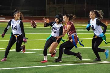 Pahrump Valley High School junior linebacker Ember Castaneda-Dabney attempts to pull a flag fro ...